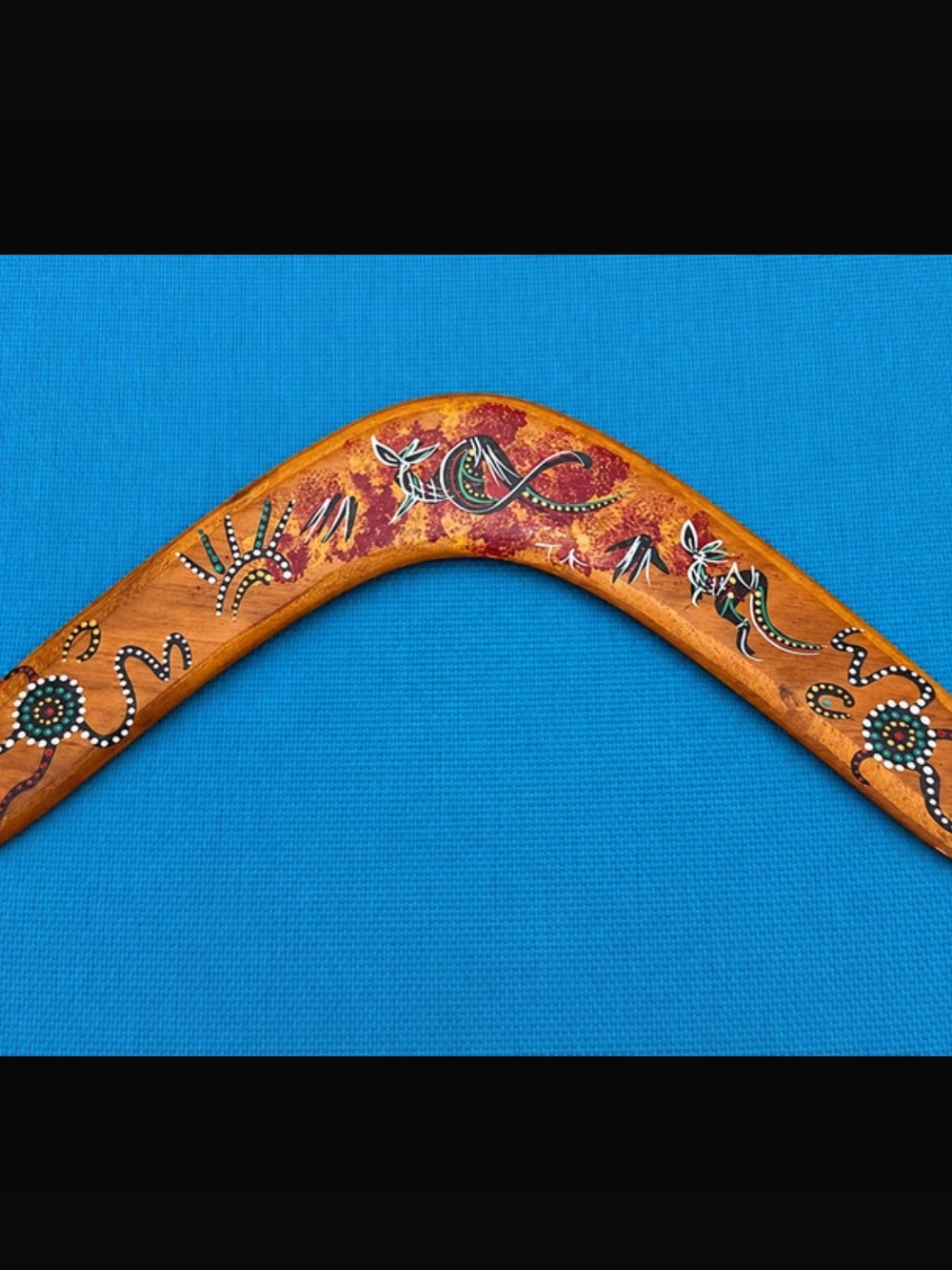 Hand-Painted Orange Decorative Boomerang with Aboriginal-Style Motifs